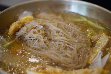 Close-up of Korean Naengmyeon Cold Noodles Topped with Sliced Beef Pancake (Yukjeon)