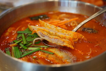 Close-up of Korean Spicy Pork Soup Served in a Traditional Brass Bowl