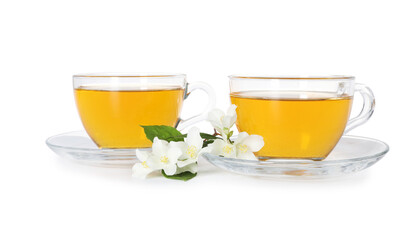 Aromatic jasmine tea in glass cups, flowers and green leaves isolated on white