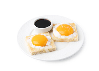 Tasty kaya toasts with half-boiled eggs and soy sauce isolated on white. Traditional asian breakfast