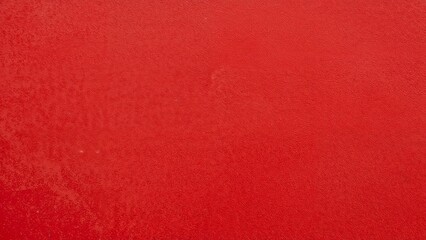 Fototapeta premium Vibrant close-up of textured red abstract wall
