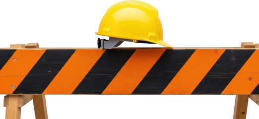 Bright yellow hard hat placed atop a striped wooden construction barrier on a transparent background