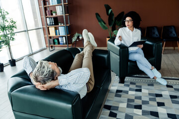 Professional consultation session between client and therapist in modern office setting exploring...