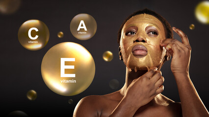 Woman applying gold face mask enriched with vitamins C and E for skincare at home in a serene,...