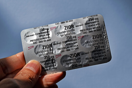 RIO DE JANEIRO, BRAZIL - June 30, 2025: Hand holding a blister of terbinafine hydrochloride pills, used to treat fungal infections