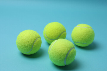 Tennis racket, sports bottle and ball on blue background