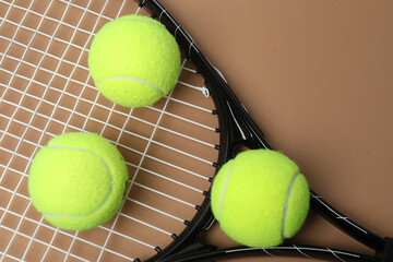 Tennis racket, sports bottle and ball on beige background