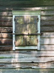 rustic wooden window frame with a weathered appearance. The window is closed. Finland, 19th century