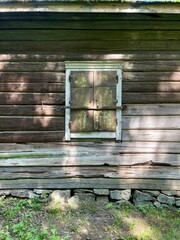 rustic wooden window frame with a weathered appearance. The window is closed. Finland, 19th century