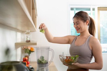 Healthy Lifestyle: Woman Preparing Smoothie in Modern Kitchen