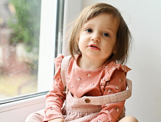 Baby girl near the window