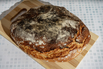 Rustic homemade bread on wooden cutting board