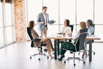 Professional colleagues collaborating during an executive business meeting in a modern office space with teamwork and strategy