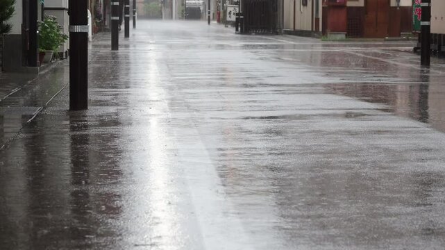 観光名所高山市の街並みで歩く若い女性と猛烈な雨の風景