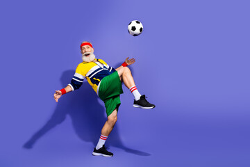 Energetic senior man practicing soccer in vibrant retro sportswear showcasing active lifestyle and cheerful expression