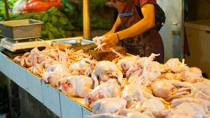 Butcher Preparing Poultry at Outdoor Market Stall