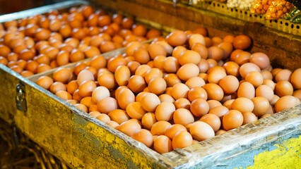 Fresh Brown Eggs in Rustic Wooden Crate at Market Stall