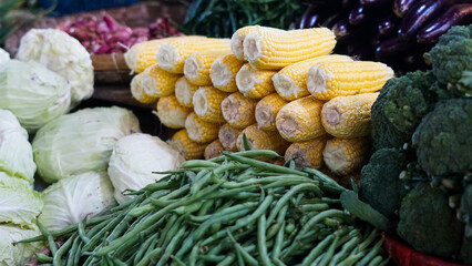 Fresh Produce Market Stall: Vibrant Corn, Green Beans, Cabbage, and Broccoli