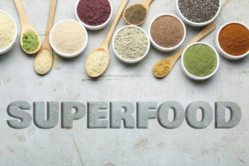 Superfood. Different powders and chia seeds on grey table, flat lay