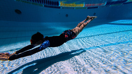 Sportsman swimming  trainning  of dolphin kick as freedive in a pool at summer vacation