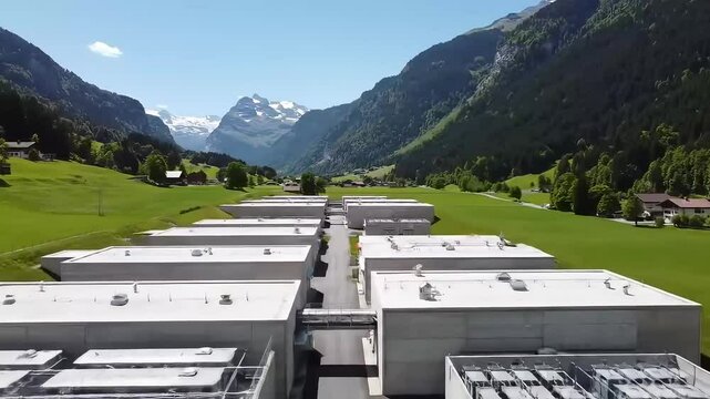 Aerial View: Low-Profile Swiss Data Center Bunkers Integrated into Sunlit Alpine Valley Landscape