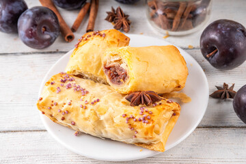 Vertuta, homemade strudel hand pies with sweet plum jam and spicy filling, with cinnamon, on a...