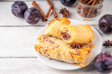 Vertuta, homemade strudel hand pies with sweet plum jam and spicy filling, with cinnamon, on a...