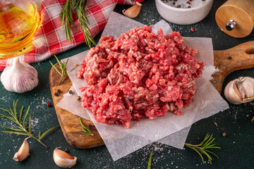Ground beef, minced meat ready for cooking dinner. Food cooking background with raw minced meat,...