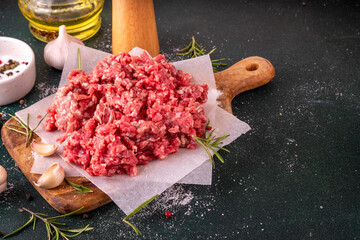 Ground beef, minced meat ready for cooking dinner. Food cooking background with raw minced meat,...