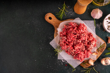 Ground beef, minced meat ready for cooking dinner. Food cooking background with raw minced meat,...