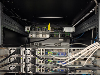 Close-up of powerful server equipment and network cables inside a data center rack, showcasing...