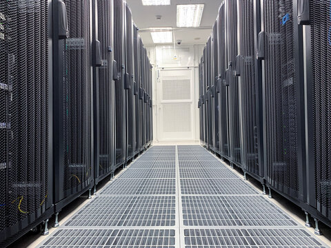 Modern IT server room with rows of black server racks in a high-tech data center environment, showcasing advanced technology, cyber security, and digital infrastructure. - Powered by Adobe