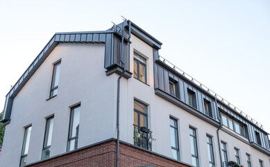 A large building with a brick facade and a metal roof