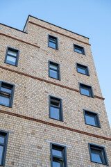 A tall brick building with many windows