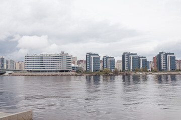 The view features contemporary buildings lining the Neva River in St. Petersburg, reflecting urban...
