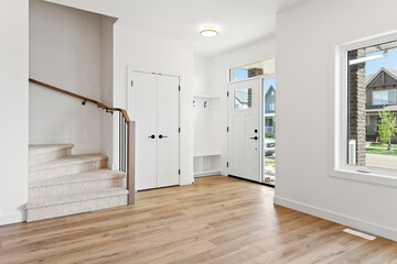 White house with a staircase leading up to the second floor