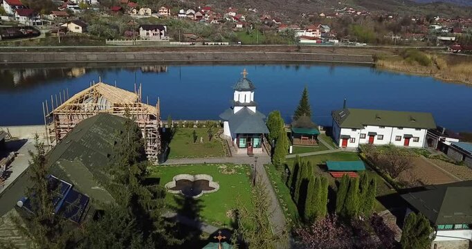 Drone shot of the Ostrov Monastery on the Ostrov Island on Olt River in Constanta County, Romania