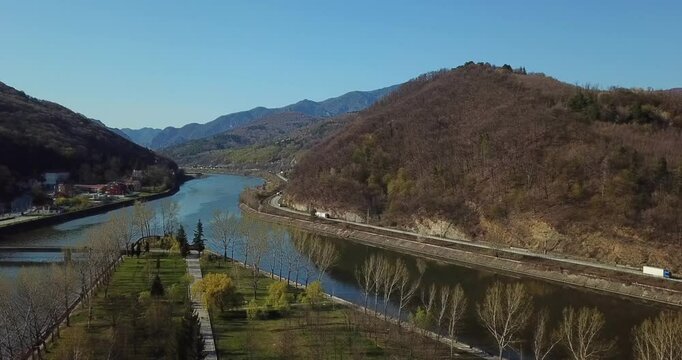 Descending drone footage of Ostrov Island on Olt River in Constanta County, Romania on a sunny day