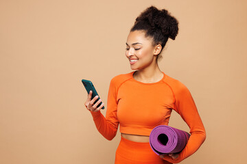 Young strong fitness trainer instructor sporty woman sportsman wear orange clothes spend time in...