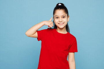 Little child kid girl 8-9 years old wears red t-shirt have fun doing phone gesture like says call...