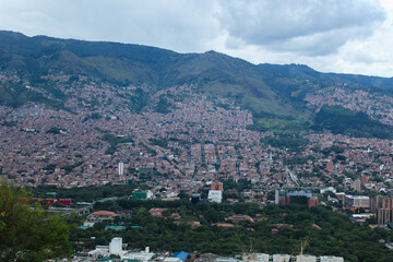 photograph taken of the city of Medellin from one of its hills with a view towards its high and...