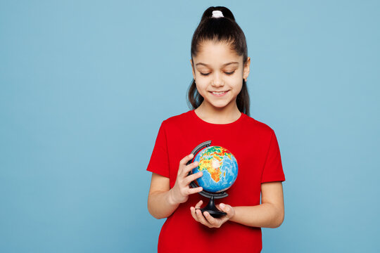 Little kid girl 8-9 years old wear red t-shirt have fun hold in hands Earth world globe isolated on pastel light blue color background child studio portrait Mother's Day love family lifestyle concept - Powered by Adobe