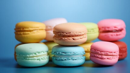 Obraz premium Colorful macarons stacked in an artistic arrangement against a light blue background