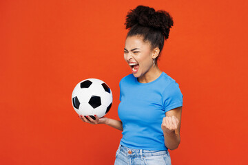 Young woman fan in blue t-shirt cheer up support football sport team holding in hand soccer ball...