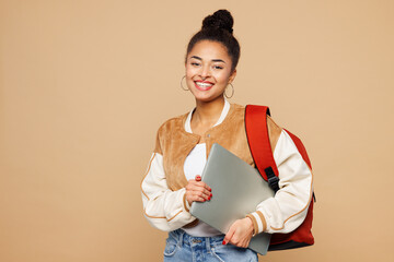 Young happy smart girl IT student wear casual clothes backpack bag hold closed laptop pc computer...