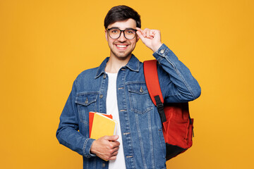 Young smiling happy cheerful satisfied boy student he wear jeans casual clothes glasses backpack...