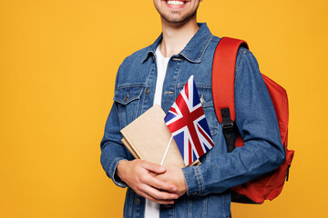 Close up cropped young clever English boy student wear denim casual clothes backpack bag hold books...