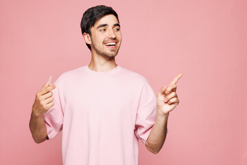 Young smiling man wearing t-shirt casual clothes hold in hand invisible transparent aligners,...