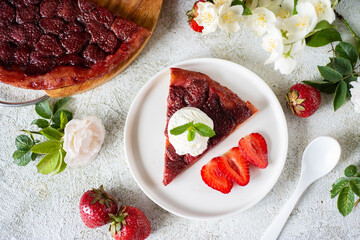Strawberry pie for dessert. A slice of strawberry pie on a white plate for breakfast. A slice of berry pie on a white plate on a light background. Close-up