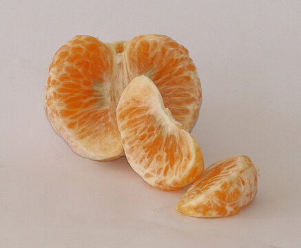 Fresh peeled kinnow on white background. Closeup of peeled clementines, Citrus fruit